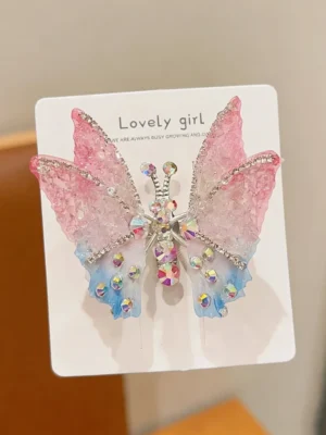 Moving three-dimensional rhinestone butterfly hairpin, in pink and blue color.